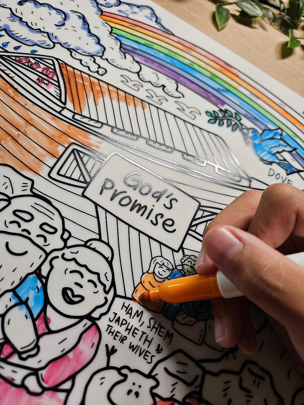 Person coloring DrawnBy: God's Promise Bible Story Story Mat with a rainbow and text, using a marker.