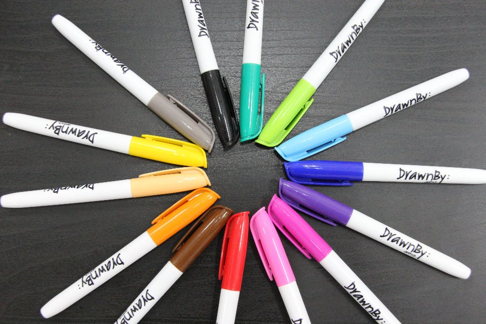 14 of our coloured whiteboard markers with 'DrawnBy' branding on a dark background