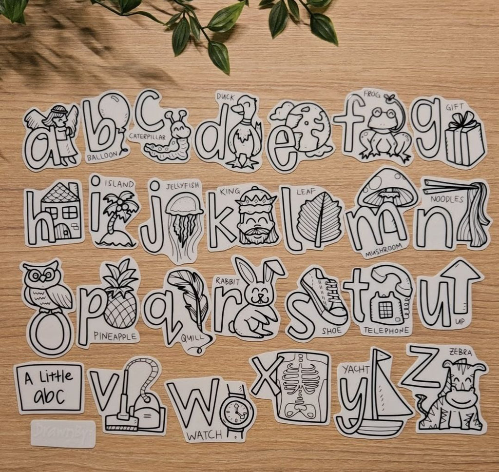 Set of black and white silicone alphabet illustration for play on a wooden surface.