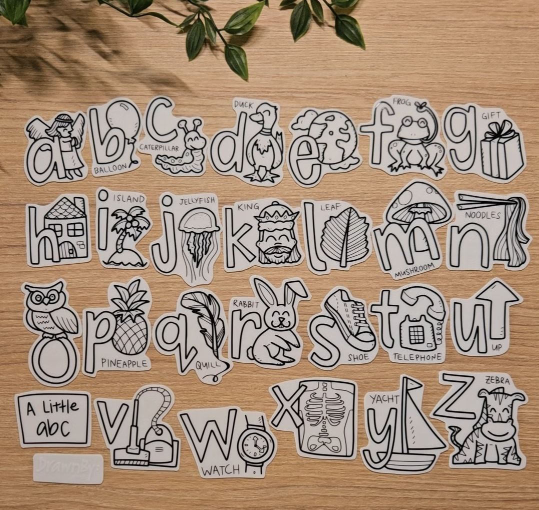 Set of black and white silicone alphabet illustration for play on a wooden surface.